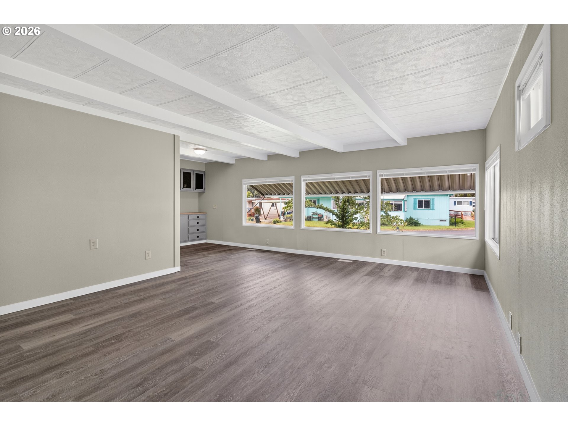 205 South 54th Street, Unit 20 Springfield, OR 97478 - Photo 4 of 32 an empty room with wooden floor and windows