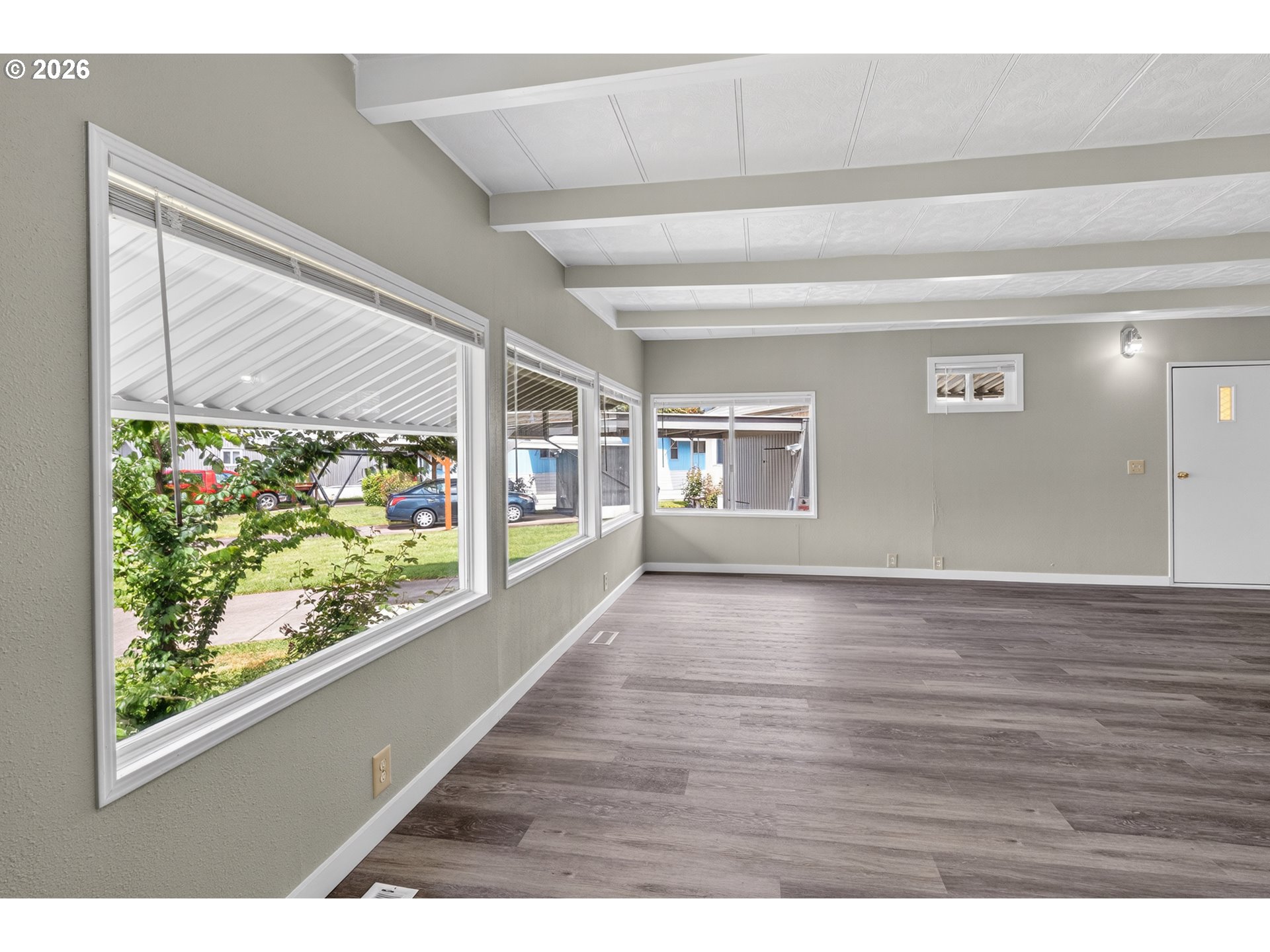 205 South 54th Street, Unit 20 Springfield, OR 97478 - Photo 5 of 32 a view of an empty room with wooden floor and a window