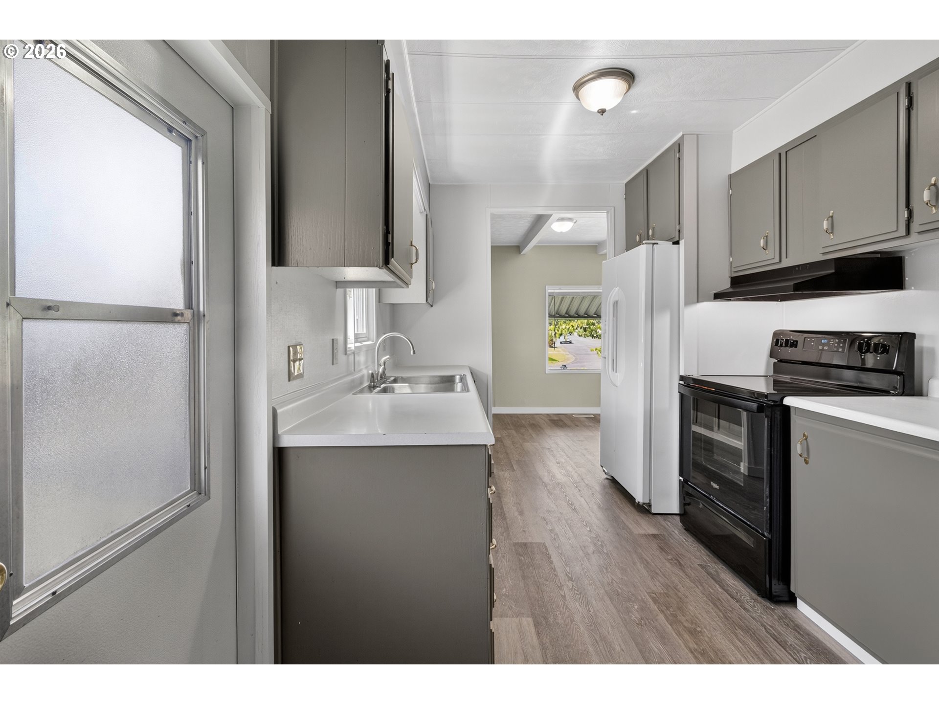 205 South 54th Street, Unit 20 Springfield, OR 97478 - Photo 9 of 32 a kitchen with a refrigerator and a sink