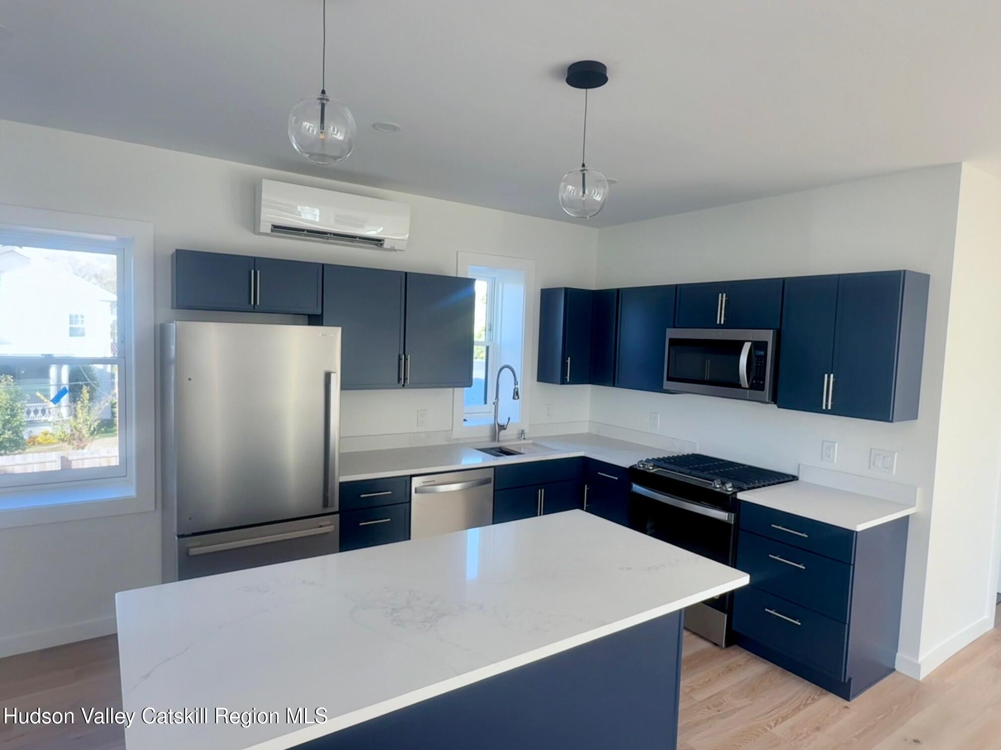 1 Main Street, Unit 2 Kingston, NY 12401 - Photo 4 of 14 a kitchen with stainless steel appliances a refrigerator and a counter space