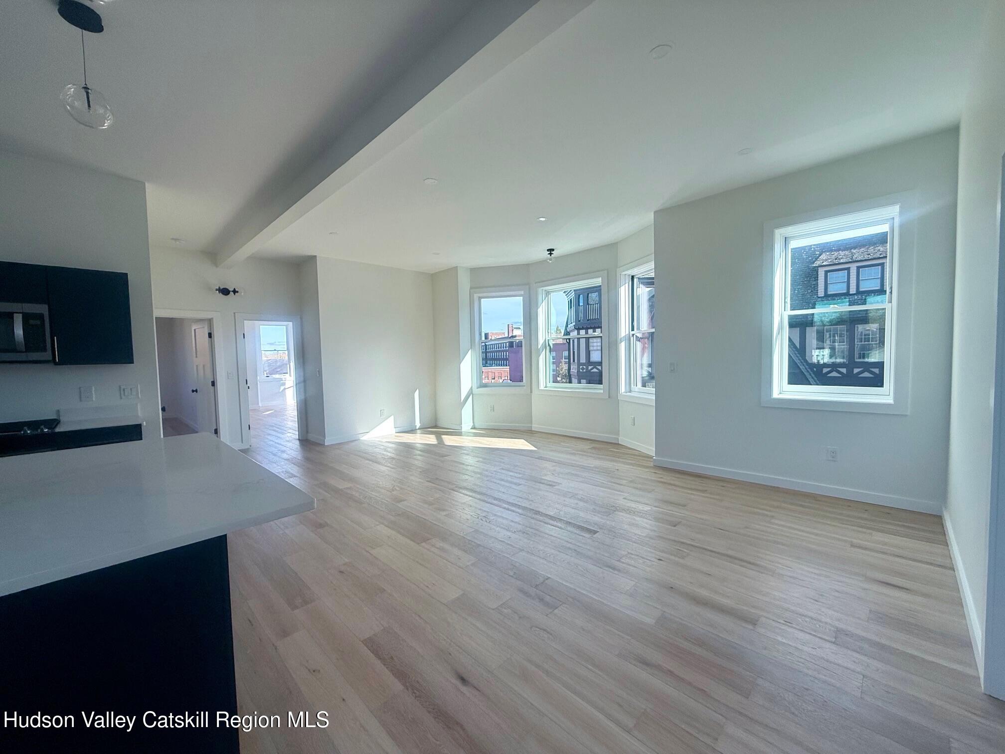 1 Main Street, Unit 2 Kingston, NY 12401 - Photo 6 of 14 a view of empty room with wooden floor and fan
