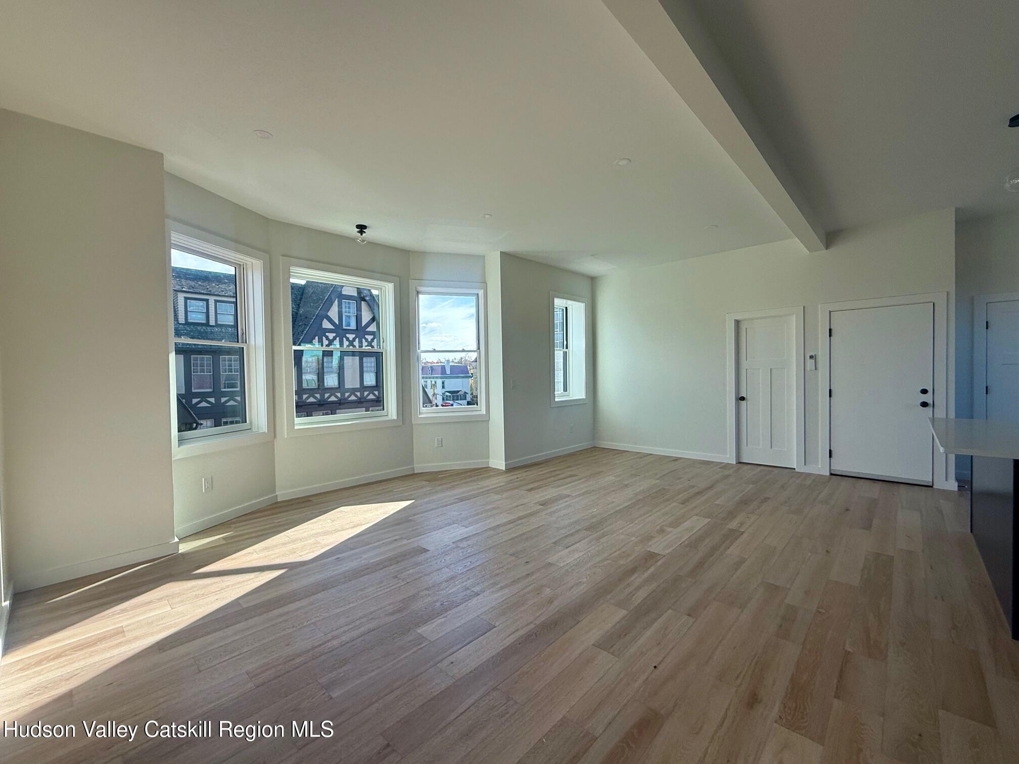 1 Main Street, Unit 2 Kingston, NY 12401 - Photo 7 of 14 an empty room with wooden floor and windows