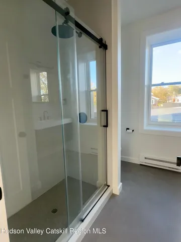 a bathroom with a glass shower door