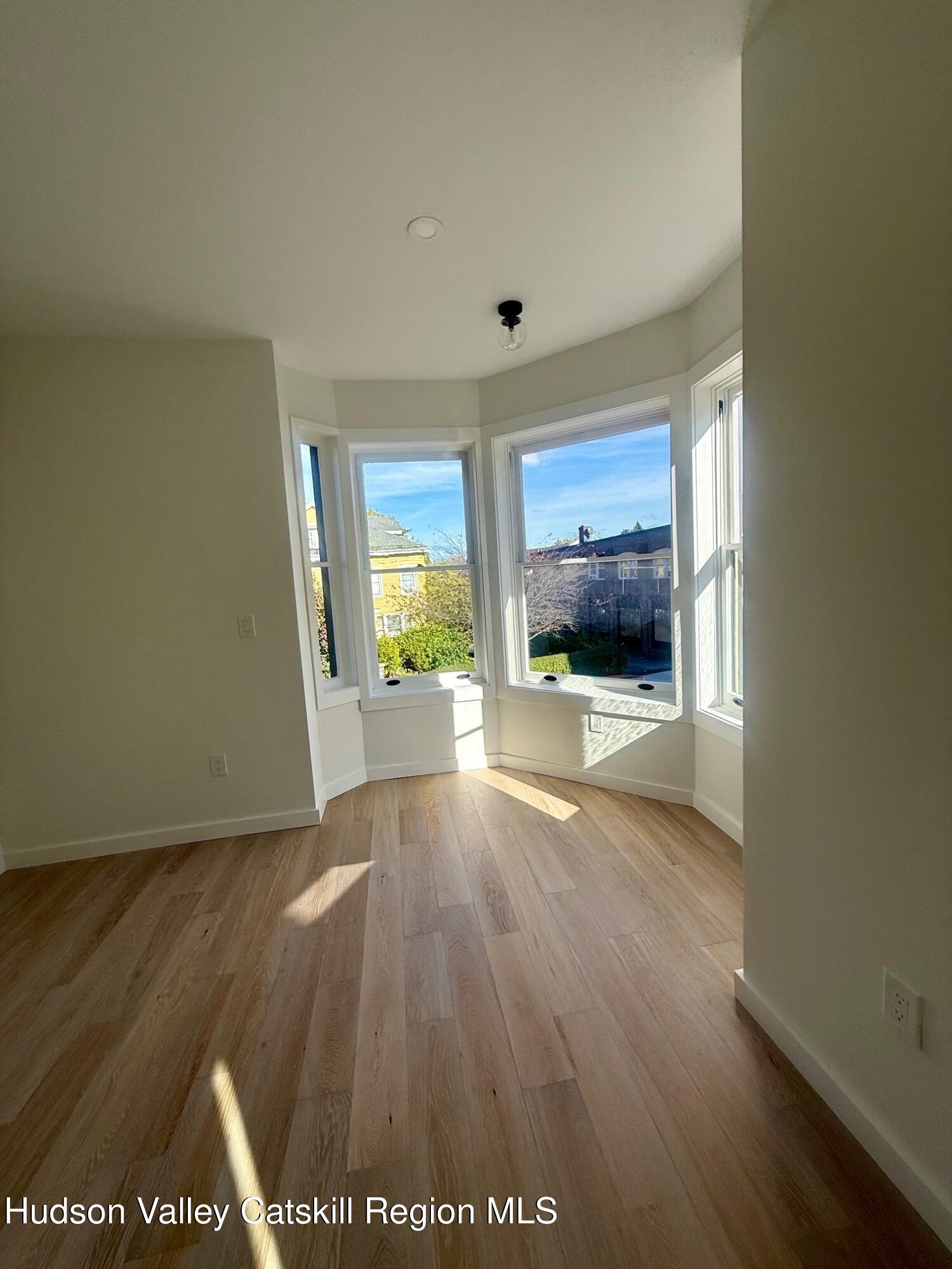 1 Main Street, Unit 2 Kingston, NY 12401 - Photo 10 of 14 a view of an empty room with wooden floor and a window