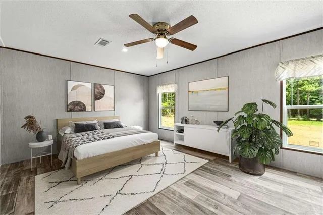 a bedroom with a bed and a large window