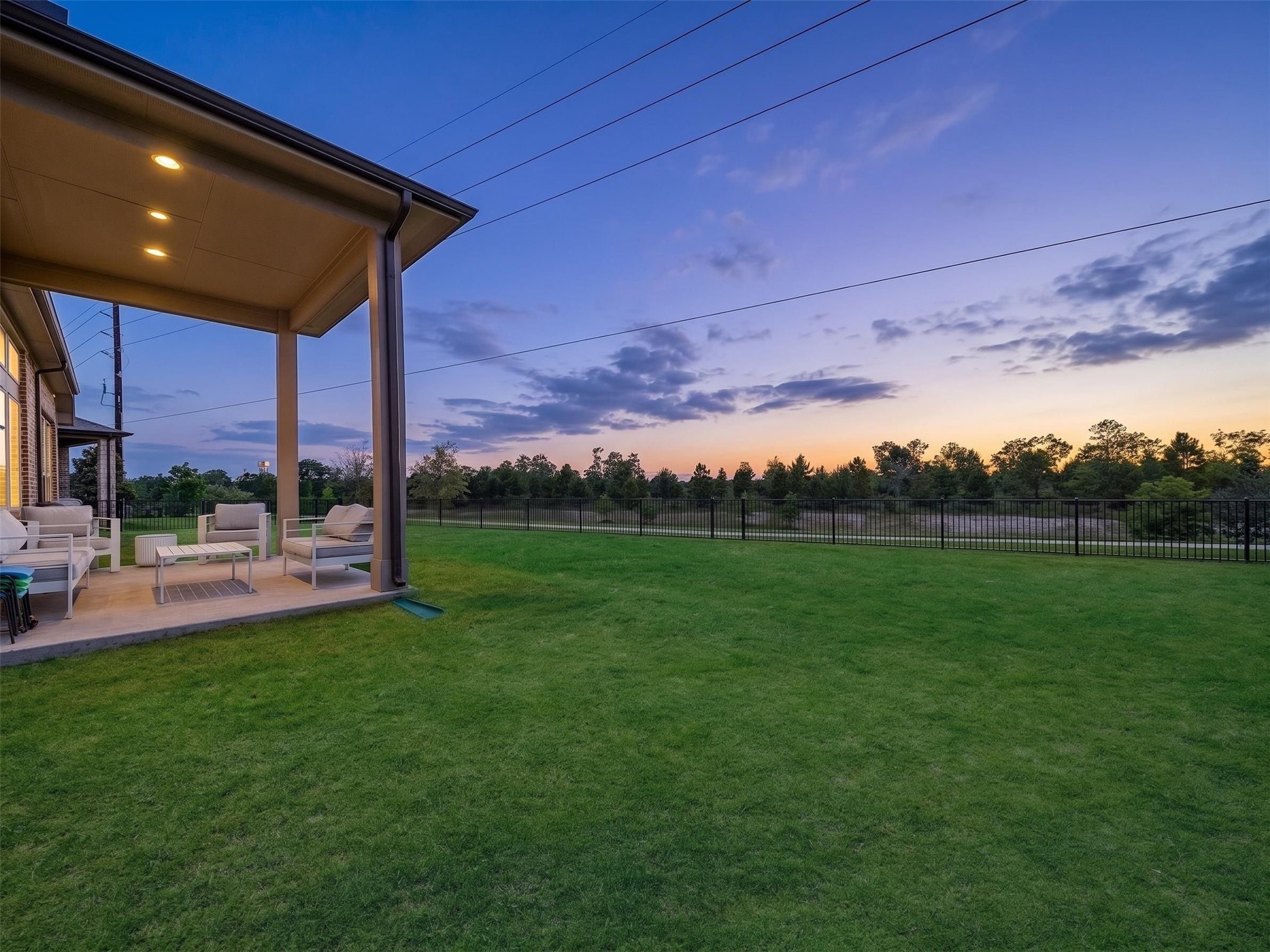 5802 Emerald Ranch Lane Fulshear, TX 77441 - Photo 42 of 45 Sunset skies and open backyard views create a truly relaxing setting, while the oversized lot offers exceptional space and privacy with no immediate rear neighbors.