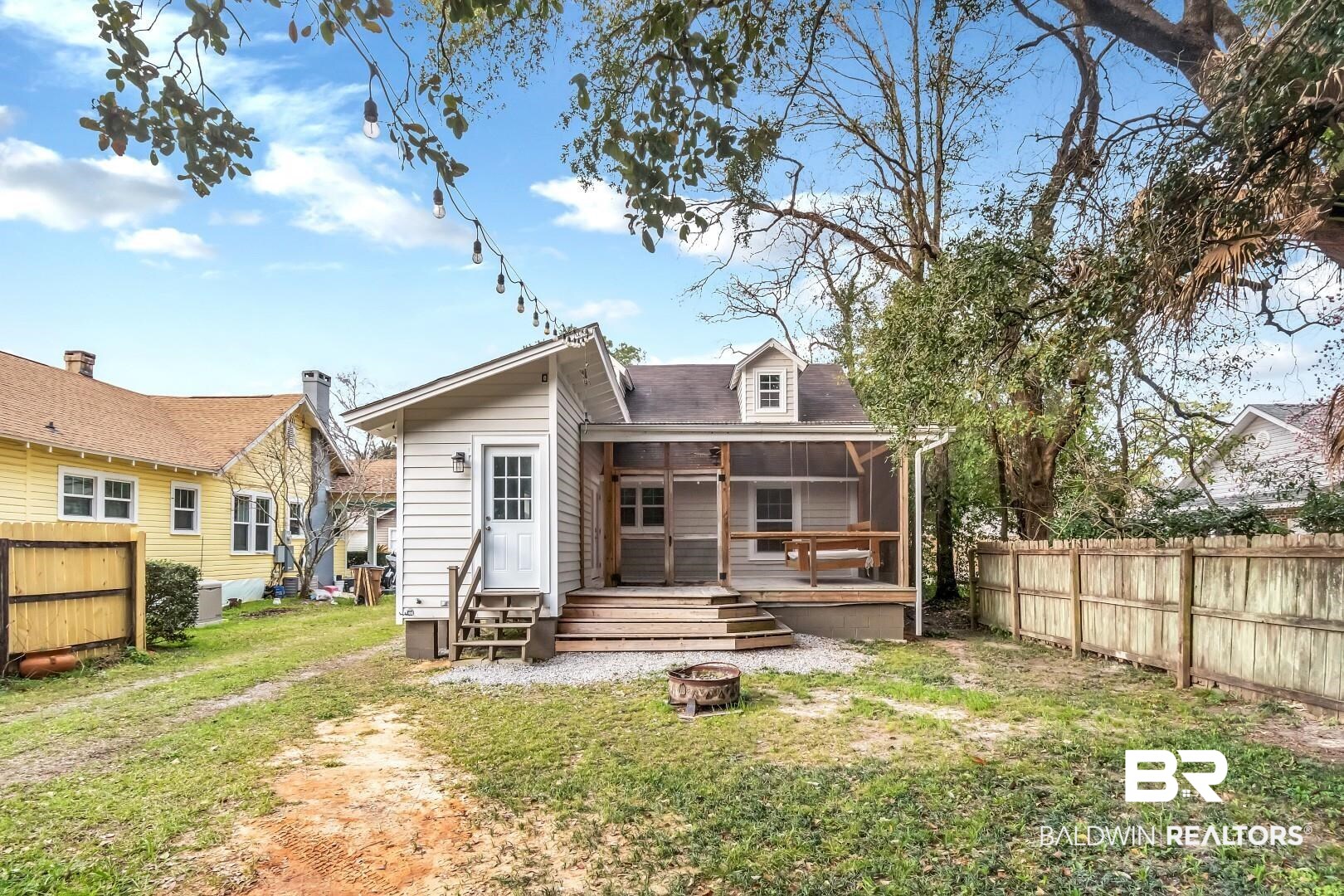 2157 Homewood Street Mobile, AL 36606 - Photo 35 of 36 Back of property with a yard, an outdoor fire pit, fence, and a sunroom