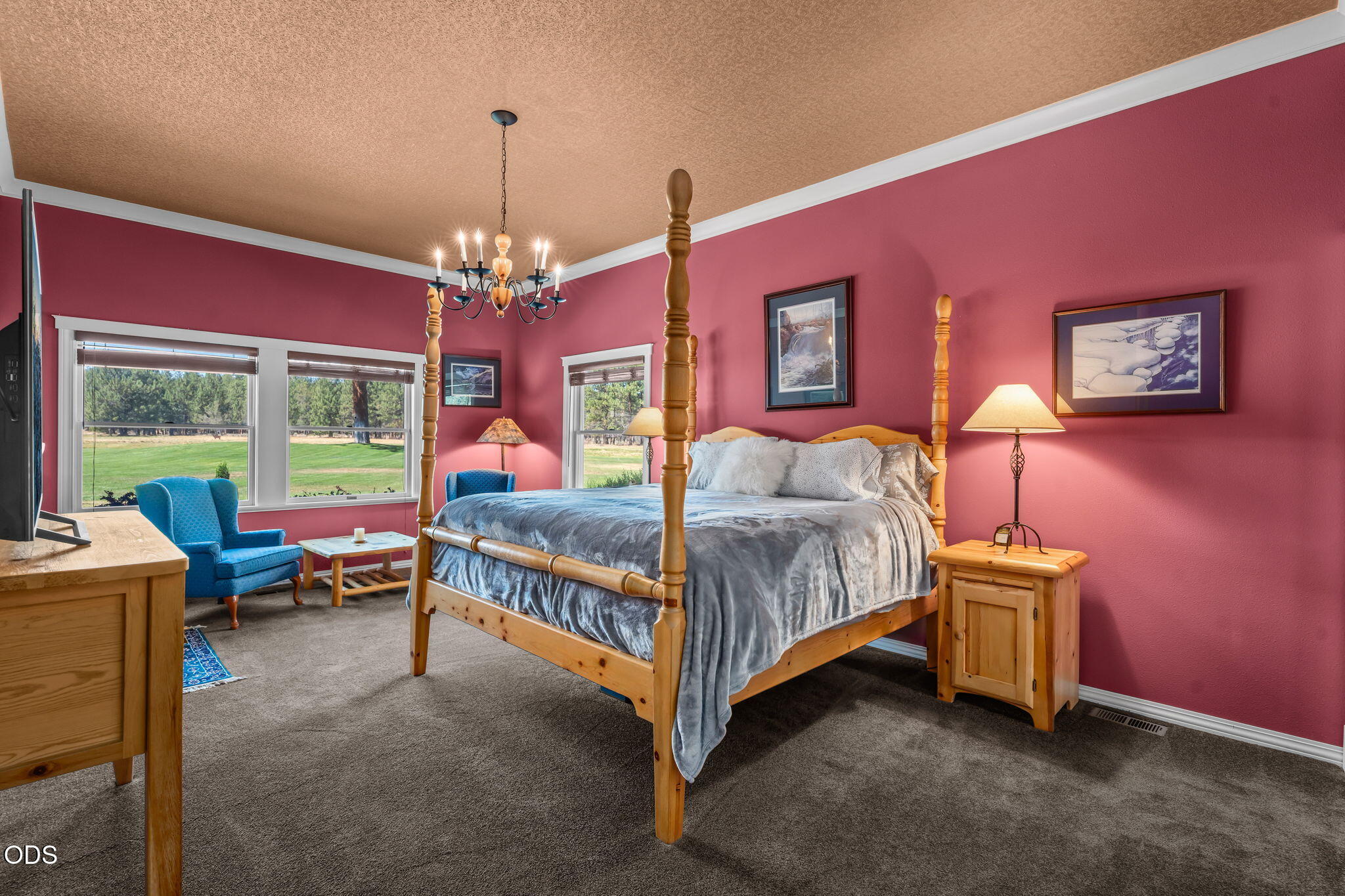 67376 Peterson Mill Road Sisters, OR 97759 - Photo 35 of 72 a bedroom with a bed and a chandelier