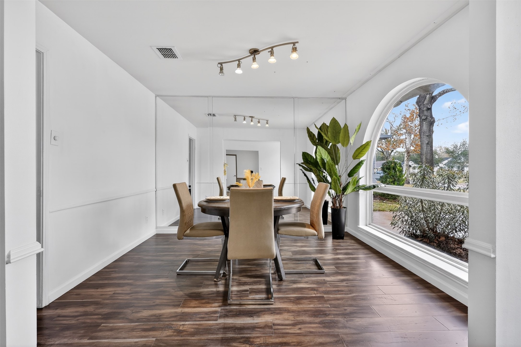 2519 Anniston Drive Houston, TX 77080 - Photo 5 of 39 a dining room with furniture potted plants and wooden floor