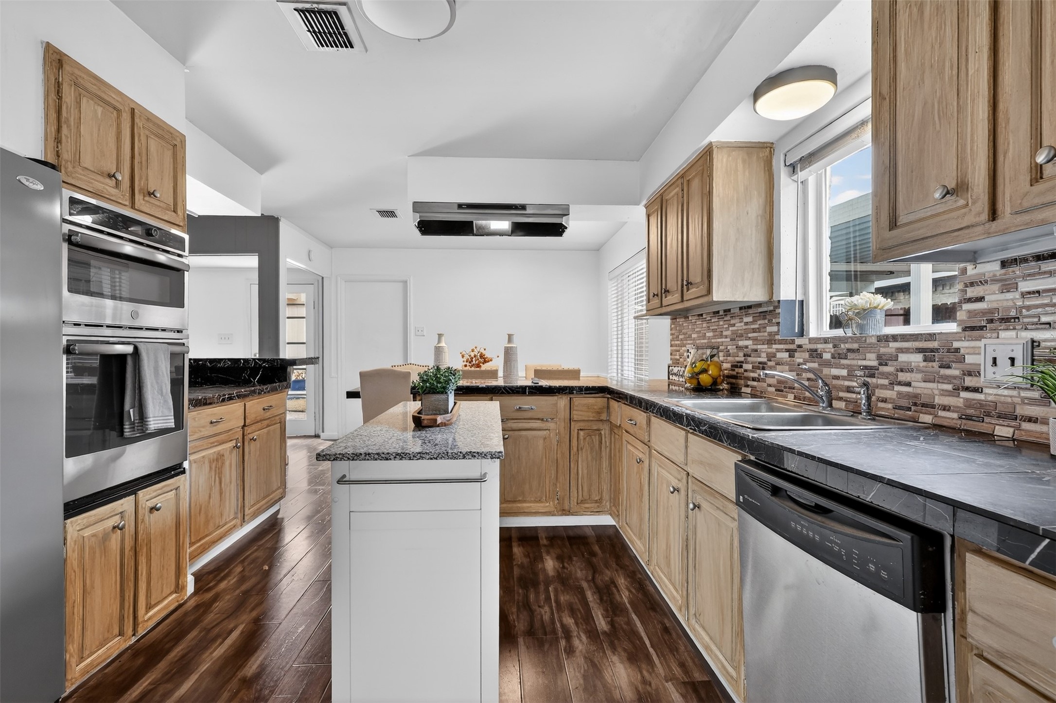 2519 Anniston Drive Houston, TX 77080 - Photo 8 of 39 a kitchen with stainless steel appliances a sink stove and refrigerator