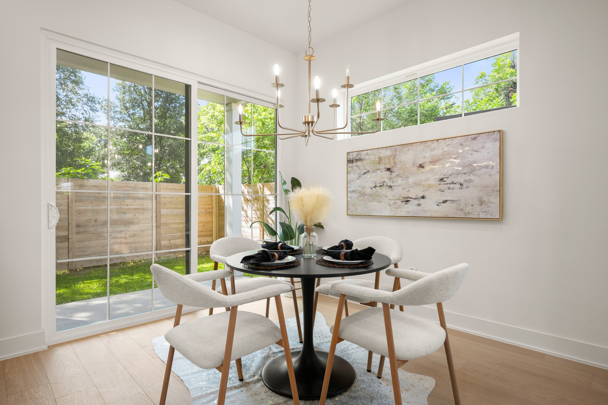 601 Vermont Road, Unit 2 Austin, TX 78702 - Photo 10 of 31 Natural illumination fills this elegant dining area, boasting hardwood flooring and convenient patio access.