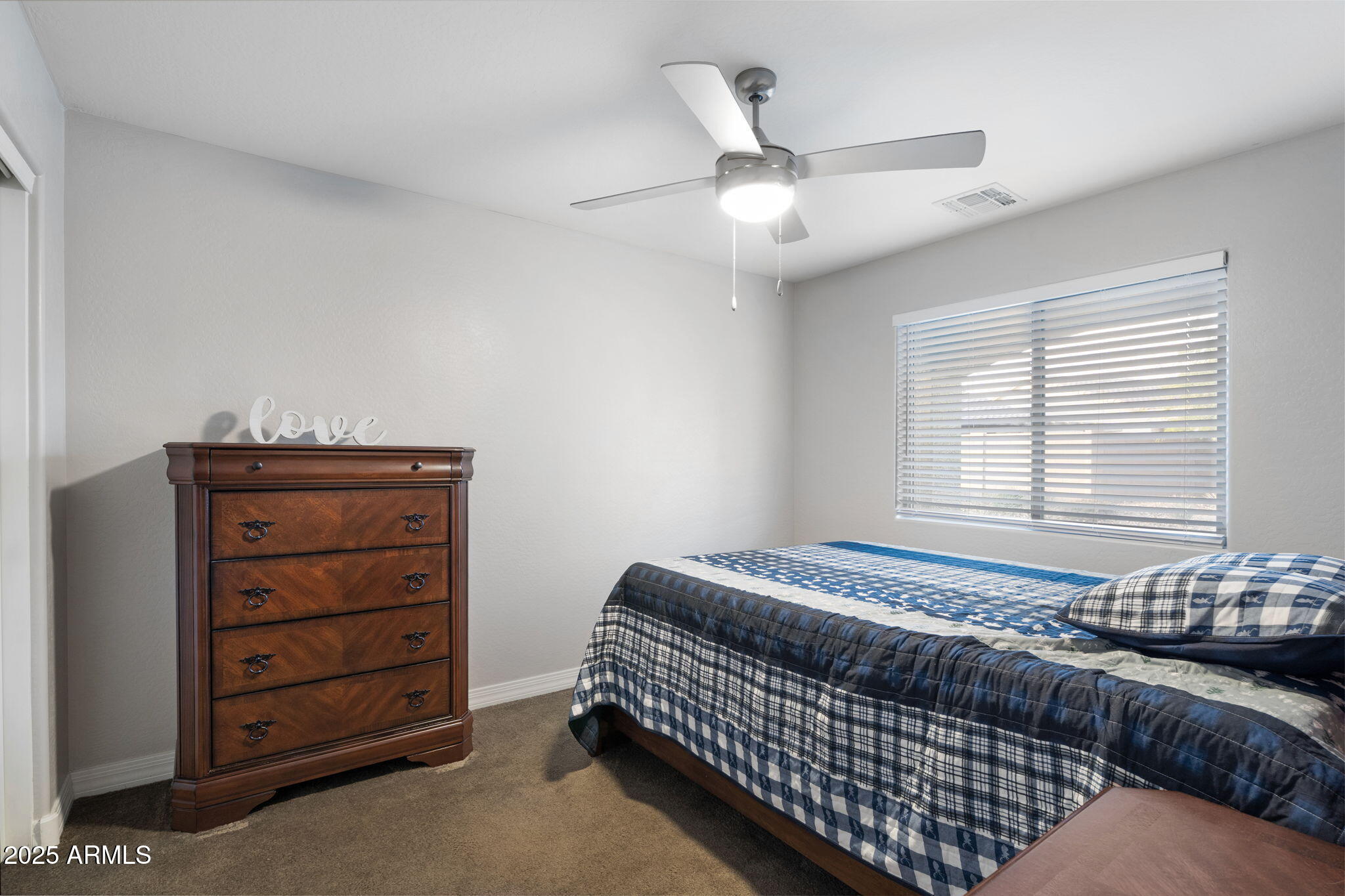 1755 East Mesquite Avenue Apache Junction, AZ 85119 - Photo 11 of 17 a bedroom with a bed and a dresser