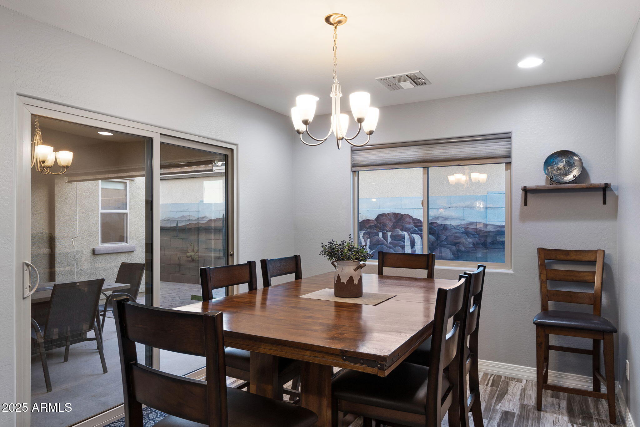 1755 East Mesquite Avenue Apache Junction, AZ 85119 - Photo 6 of 17 a view of a dining room with furniture a chandelier and wooden floor