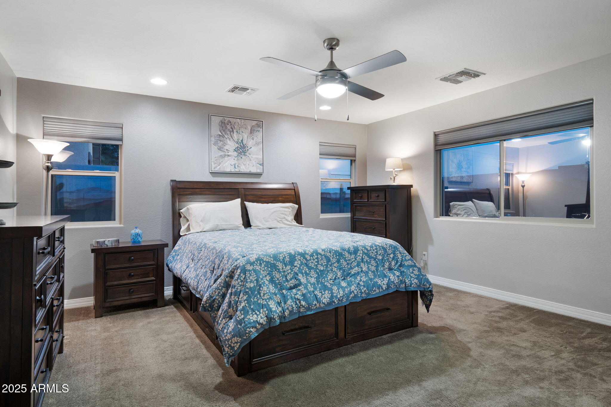 1755 East Mesquite Avenue Apache Junction, AZ 85119 - Photo 8 of 17 a spacious bedroom with a bed and a chandelier