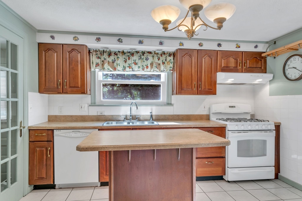 1271 Plumtree Road Springfield, MA 01119 - Photo 12 of 41 a kitchen with a sink stove and cabinets