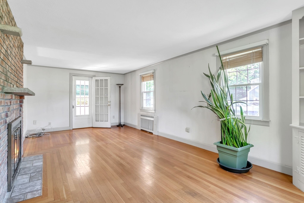 1271 Plumtree Road Springfield, MA 01119 - Photo 4 of 41 a view of an empty room with a potted plant and wooden floor