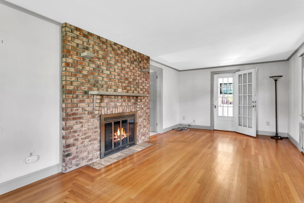 1271 Plumtree Road Springfield, MA 01119 - Photo 5 of 41 a view of an empty room with wooden floor fireplace and a window