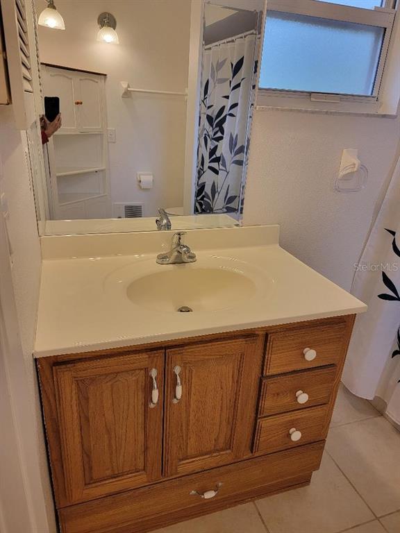 2215 Hontoon Road DeLand, FL 32720 - Photo 14 of 19 a bathroom with a sink and a mirror