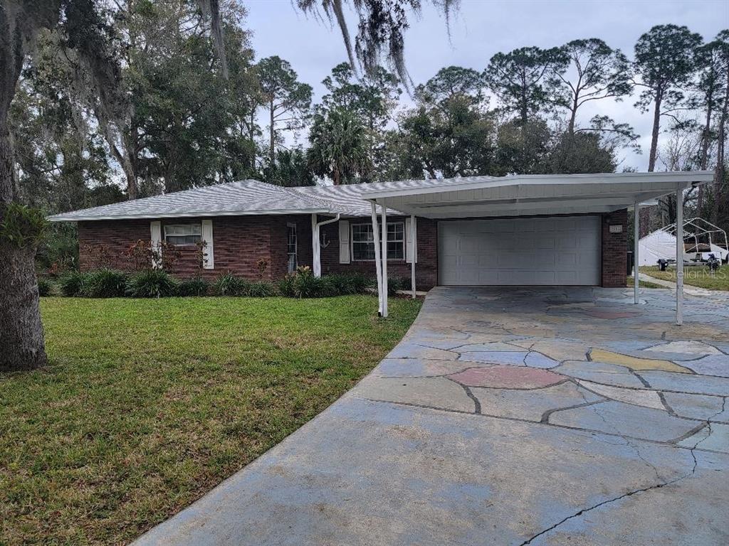 2215 Hontoon Road DeLand, FL 32720 - Photo 2 of 19 a front view of a house with garden