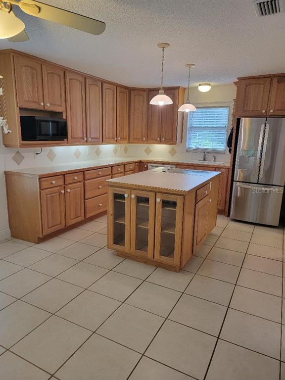 2215 Hontoon Road DeLand, FL 32720 - Photo 8 of 19 a kitchen with stainless steel appliances granite countertop a stove a sink and a microwave