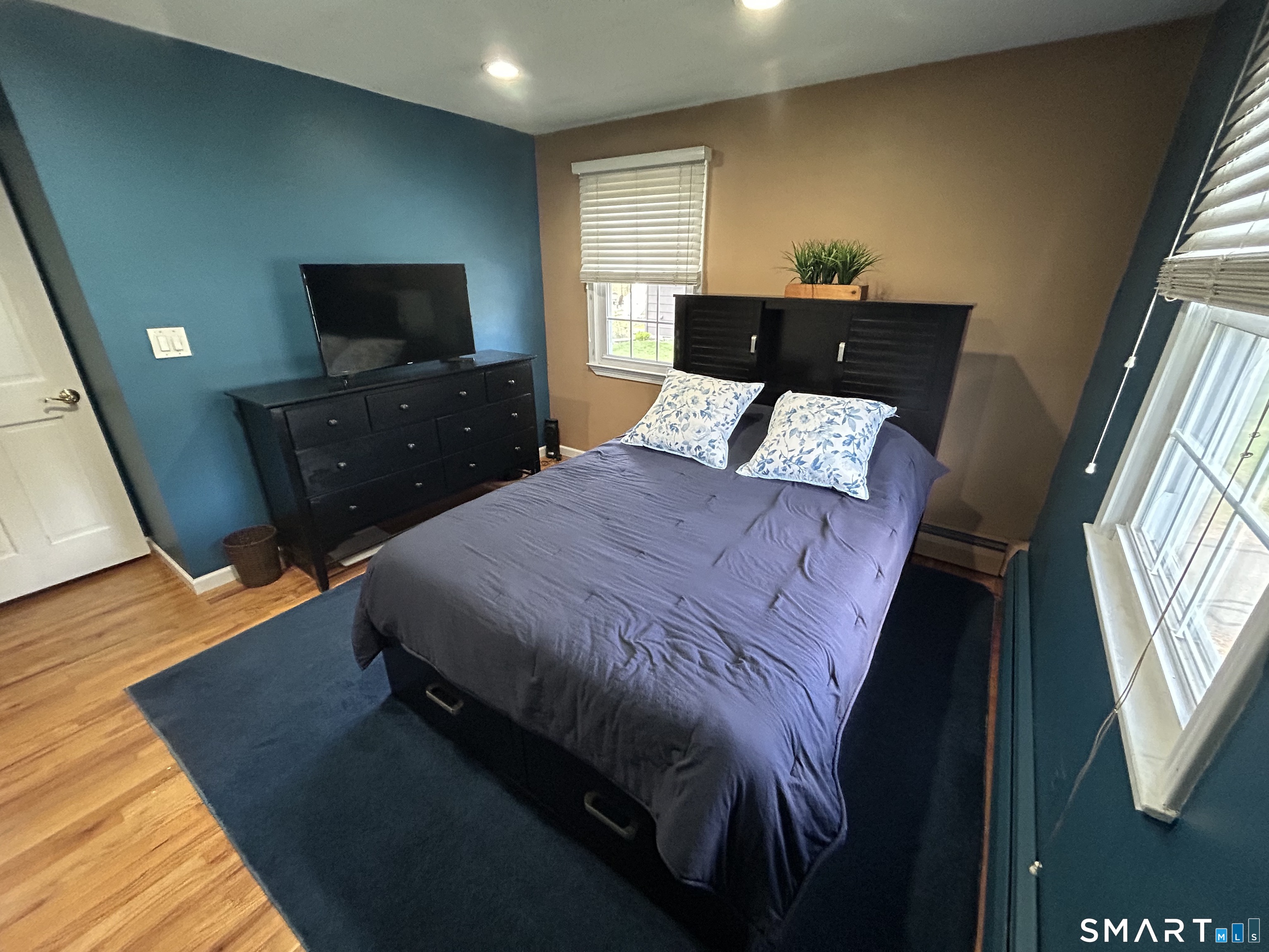 72 Nolan Road Hamden, CT 06514 - Photo 15 of 37 a bedroom with a bed and wooden floor