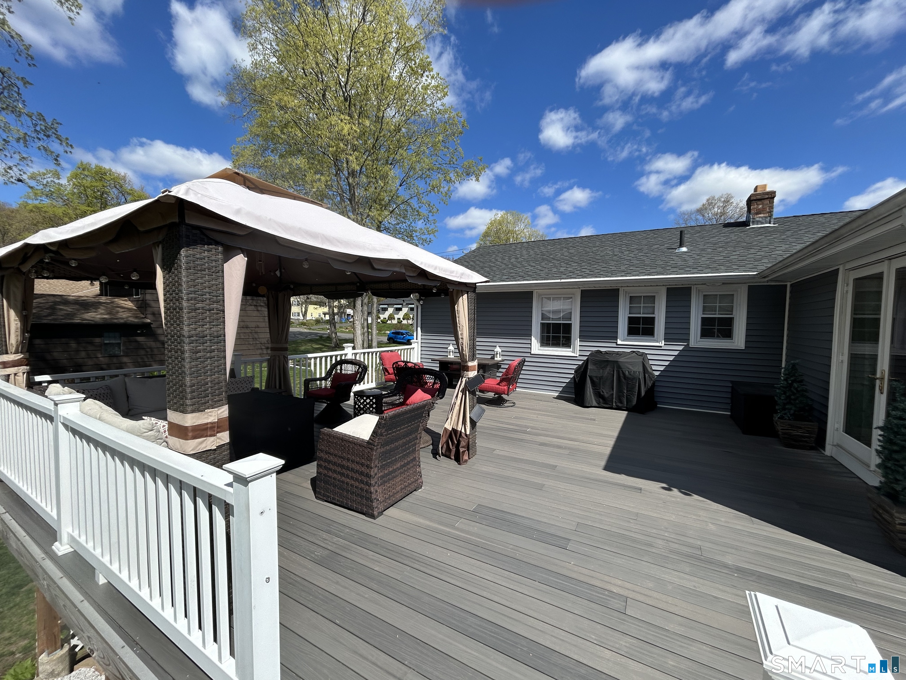 72 Nolan Road Hamden, CT 06514 - Photo 31 of 37 a view of a house with wooden deck and furniture