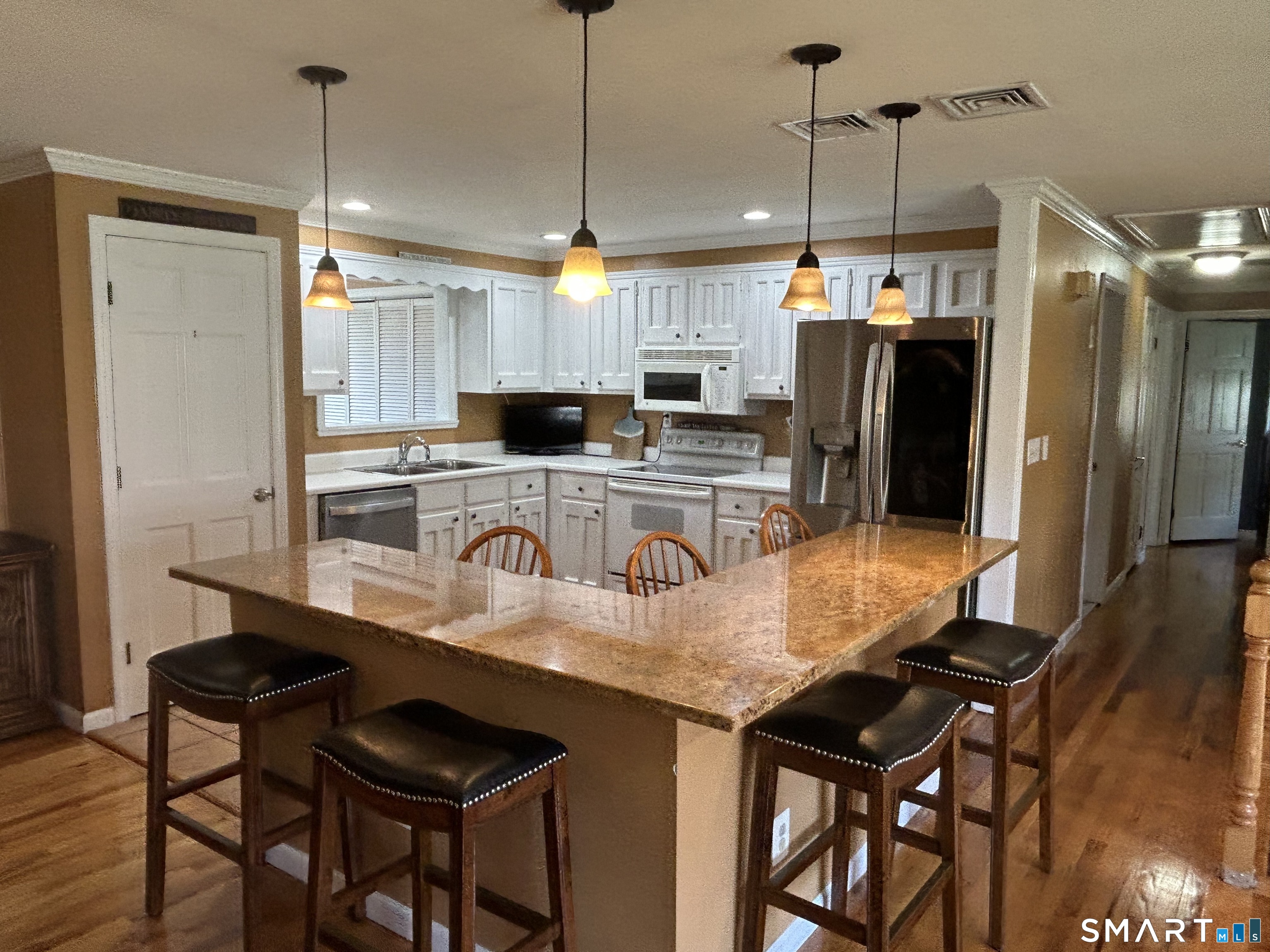 72 Nolan Road Hamden, CT 06514 - Photo 5 of 37 a kitchen with kitchen island granite countertop a table chairs stainless steel appliances and cabinets