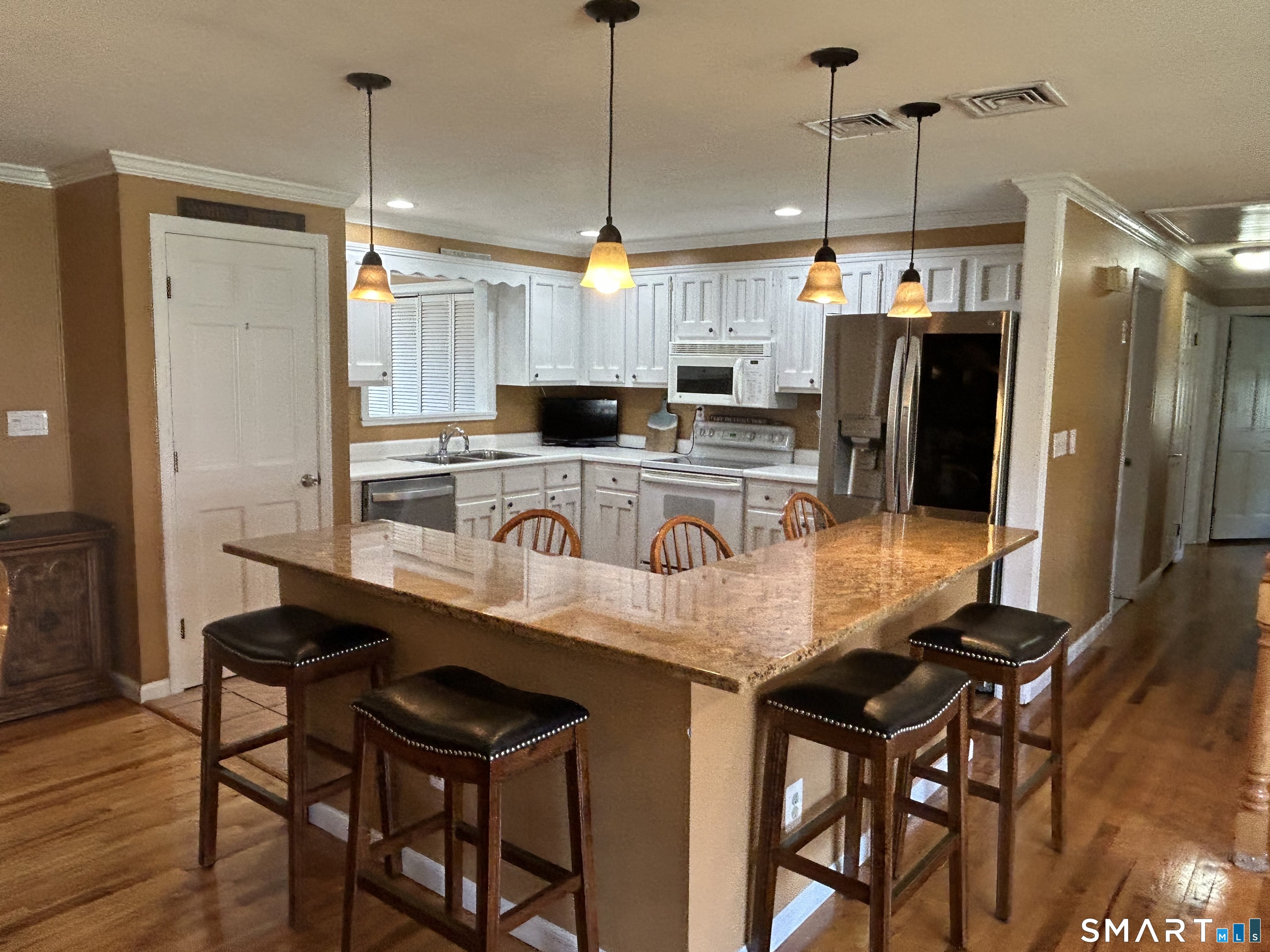 72 Nolan Road Hamden, CT 06514 - Photo 6 of 37 a kitchen with a table chairs and refrigerator
