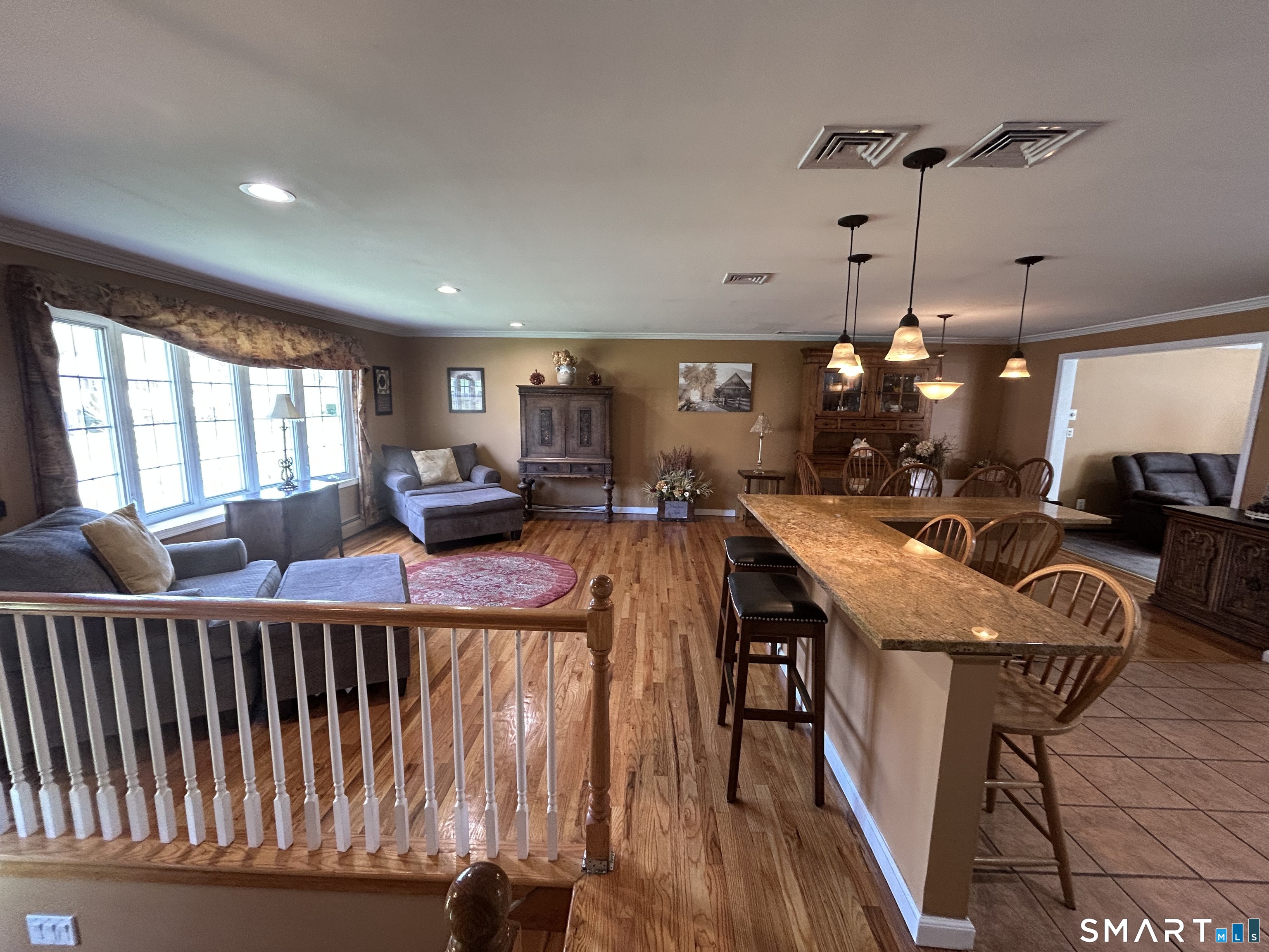 72 Nolan Road Hamden, CT 06514 - Photo 10 of 37 a living room with furniture a wooden floor and a chandelier