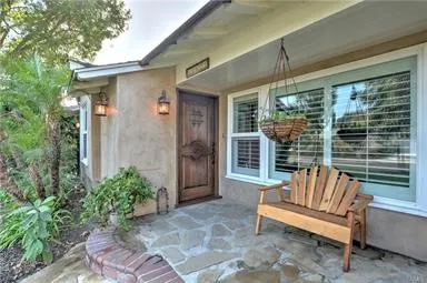 a balcony with furniture and a potted plant