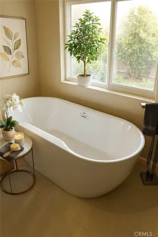 a white bath tub sitting next to a window
