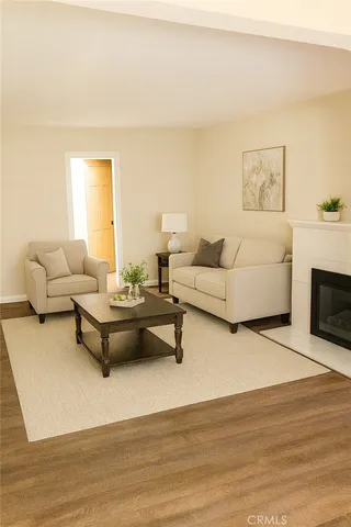 a living room with furniture a fireplace and a table
