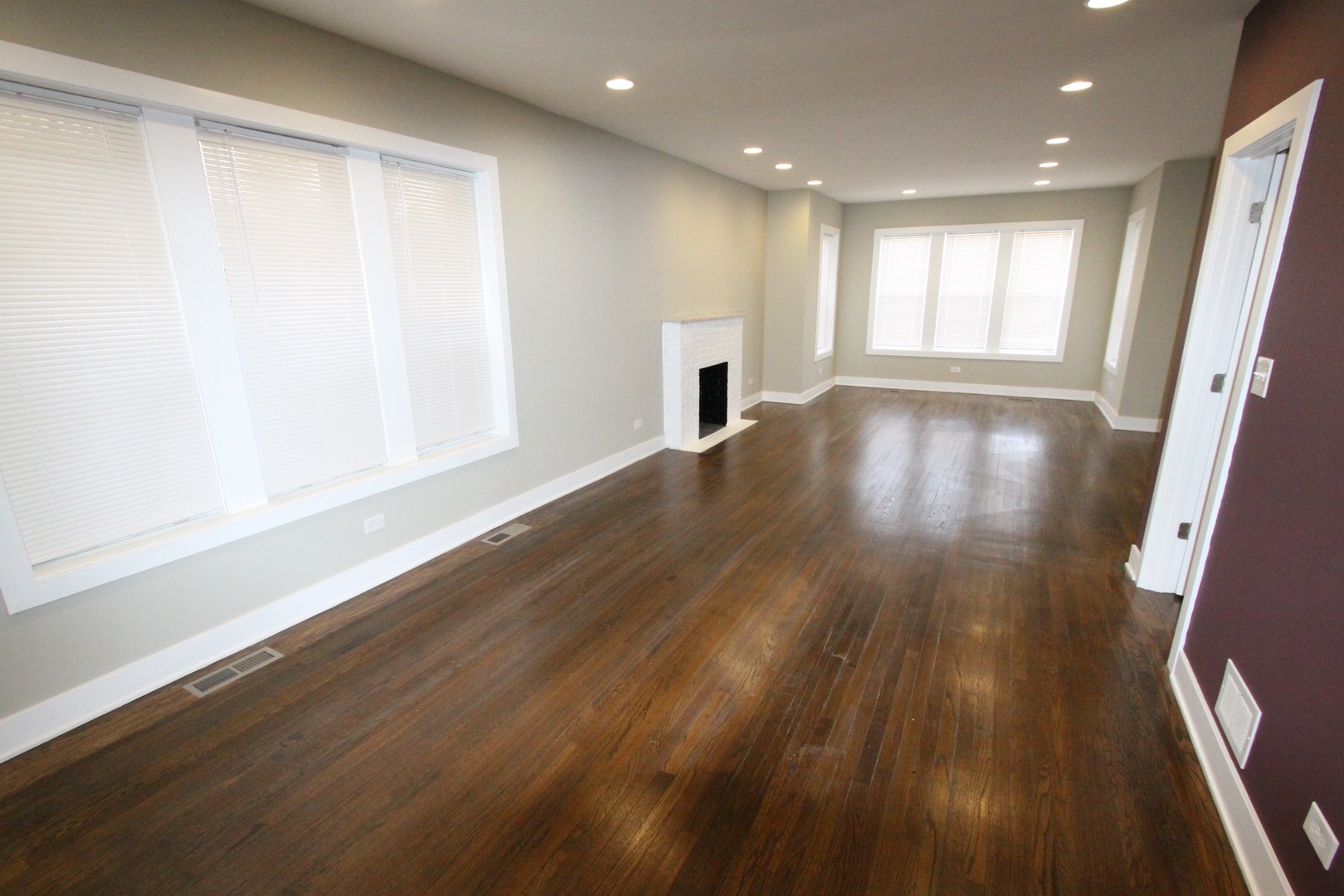 111 West 74th Street Chicago, IL 60621 - Photo 5 of 10 wooden floor in an empty room with a window