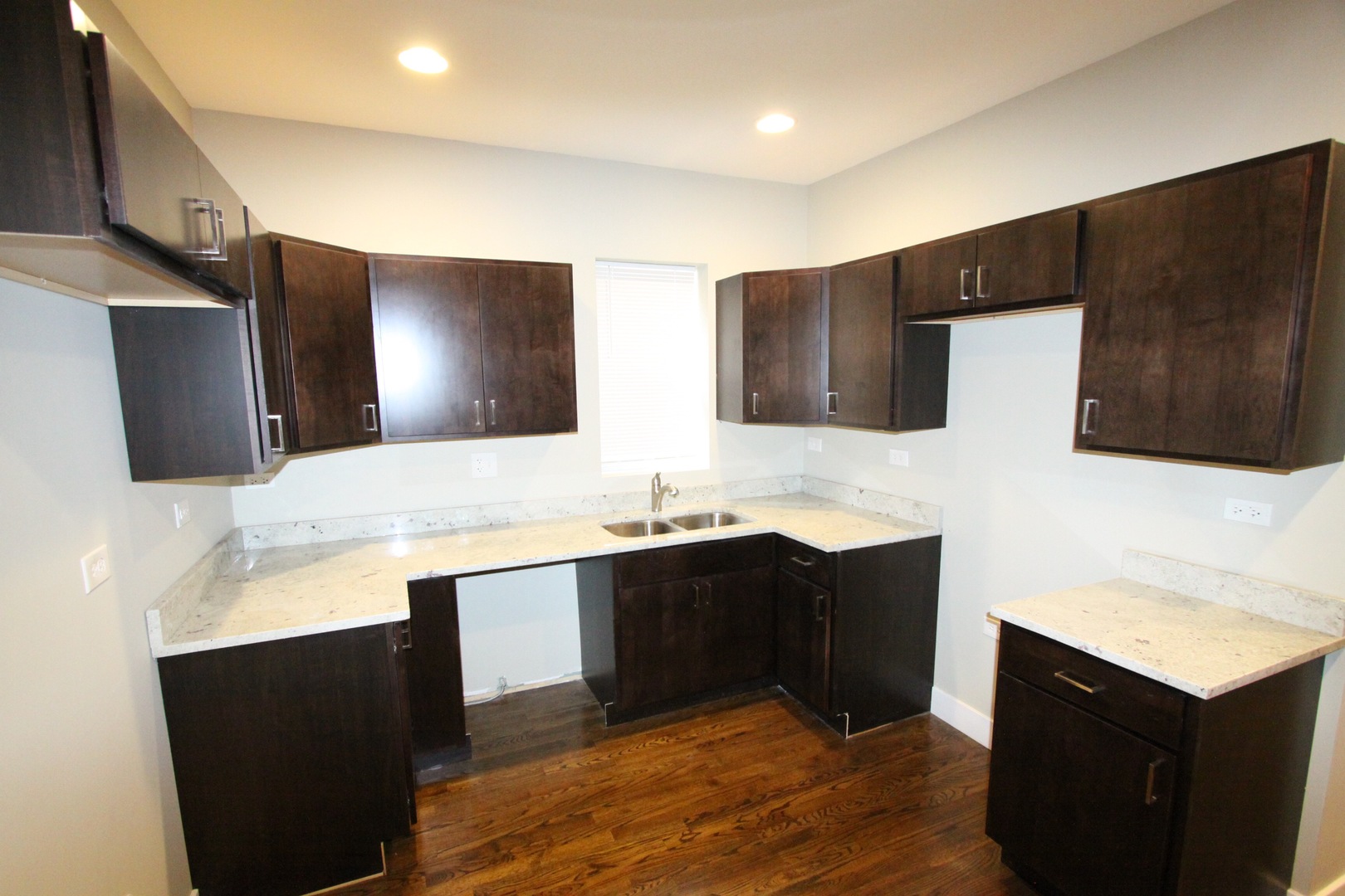 111 West 74th Street Chicago, IL 60621 - Photo 8 of 10 a kitchen with a sink and a refrigerator