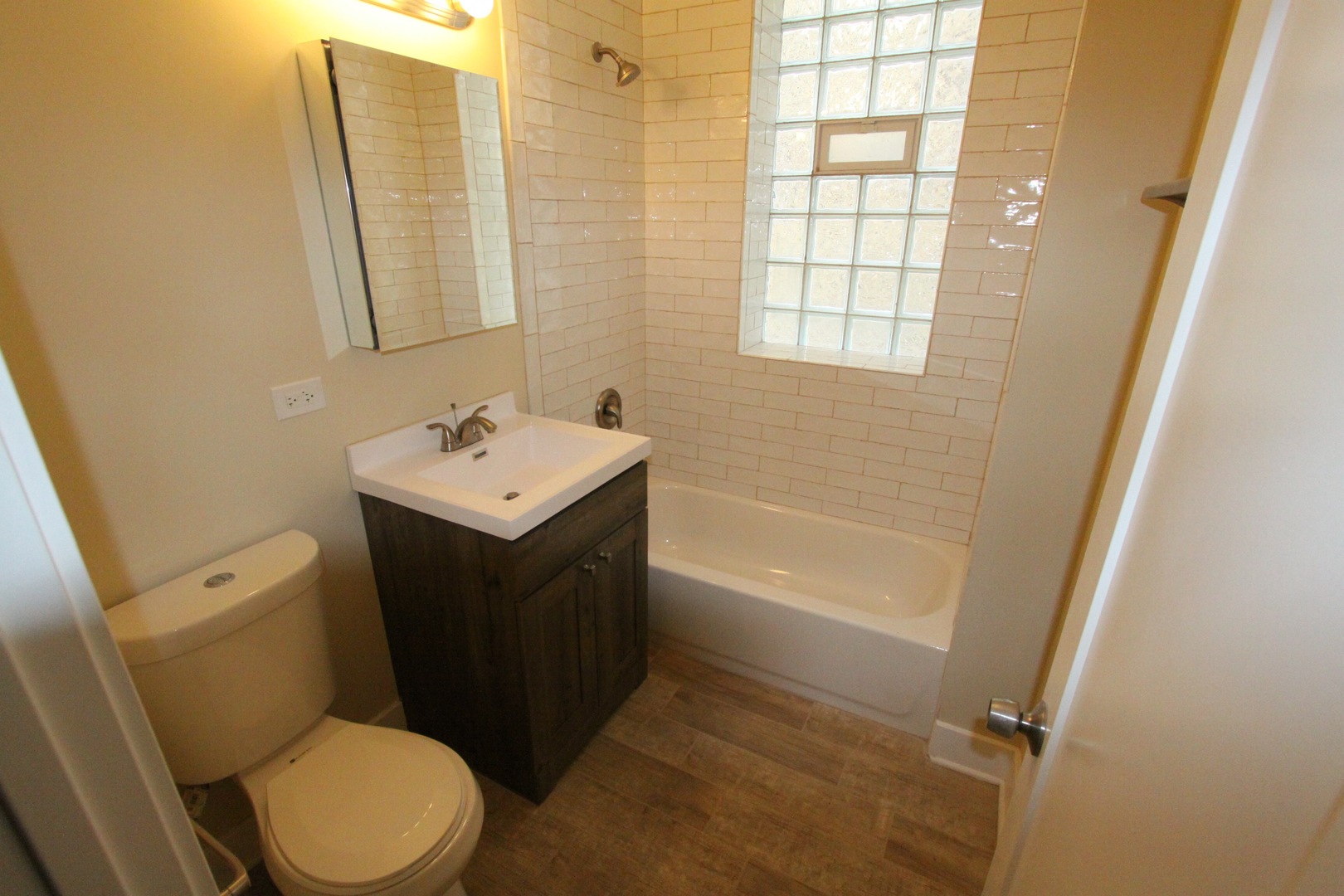 111 West 74th Street Chicago, IL 60621 - Photo 9 of 10 a bathroom with a sink vanity mirror and toilet
