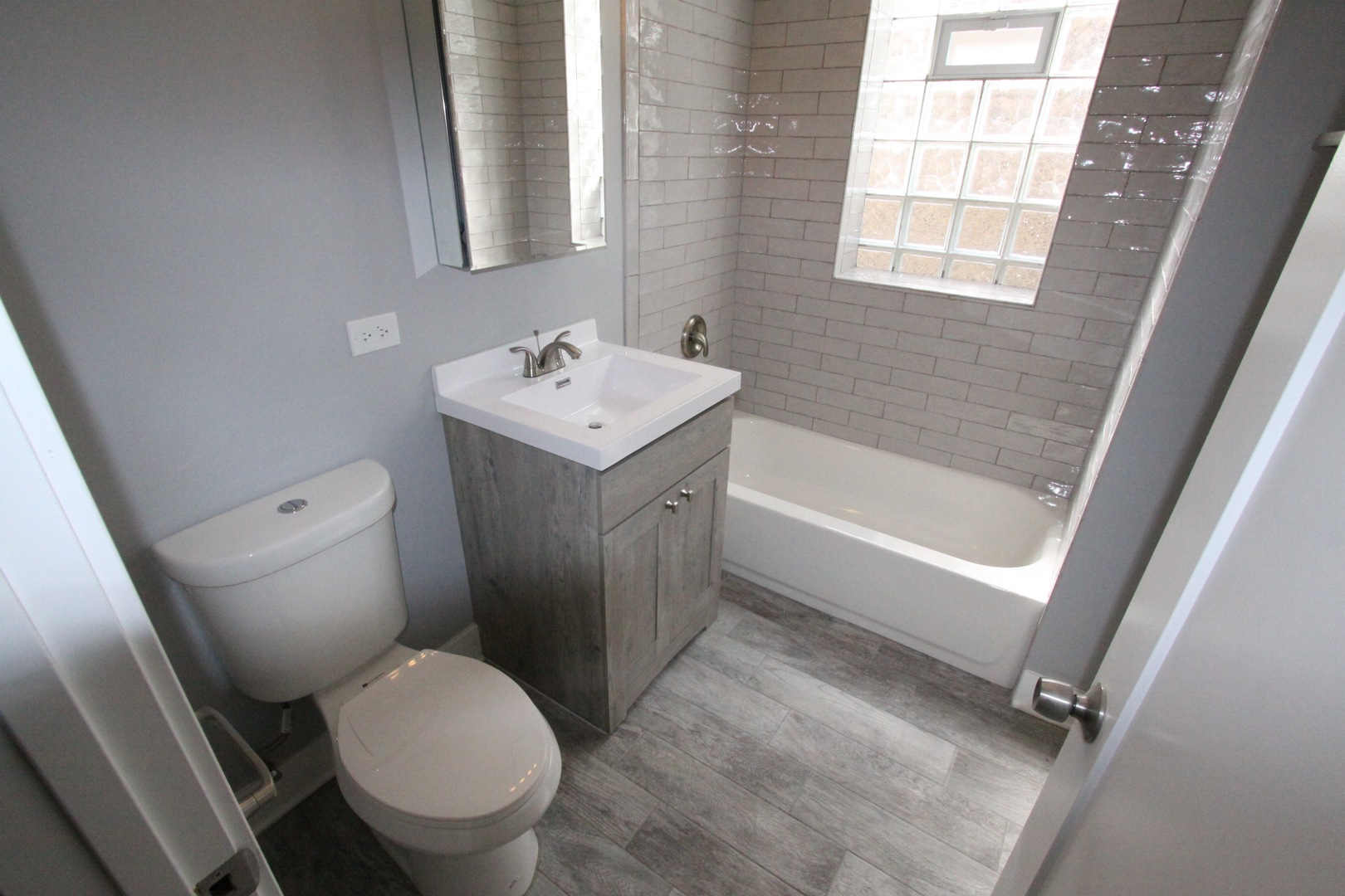 111 West 74th Street Chicago, IL 60621 - Photo 10 of 10 a bathroom with a sink toilet and shower