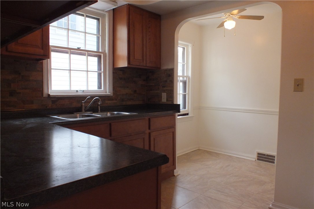 3665 Winchell Road Shaker Heights, OH 44122 - Photo 10 of 21 Kitchen view looking towards the practical eating area in the background. The eat-in area has a built-in cabinet for additional storage.