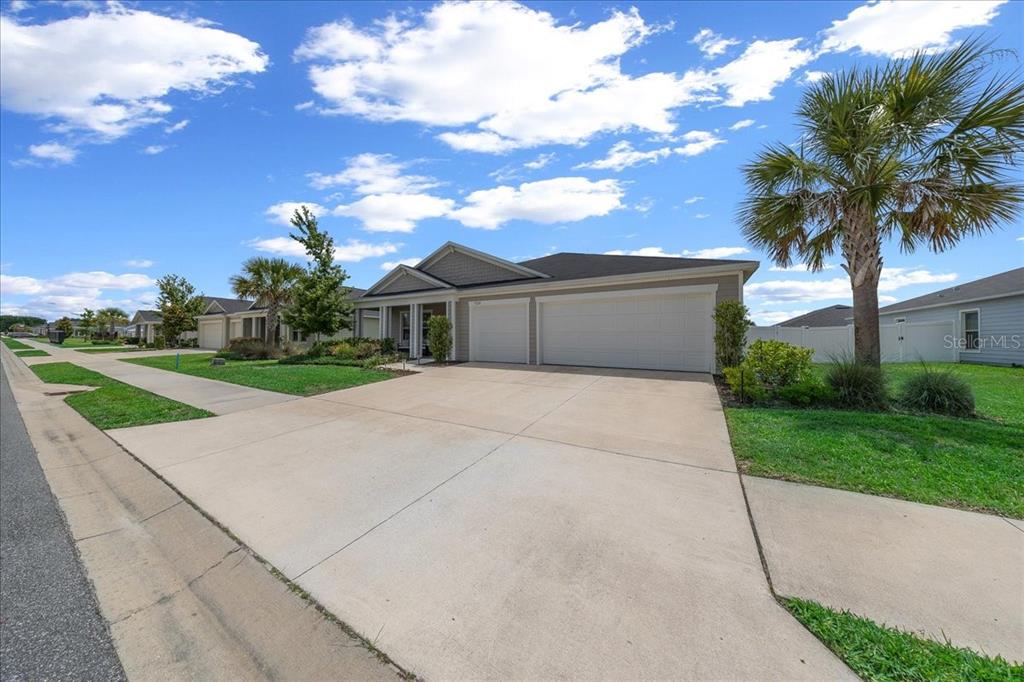 9329 Southwest 57th Terrace Ocala, FL 34476 - Photo 47 of 64 a front view of a house with a garden and yard