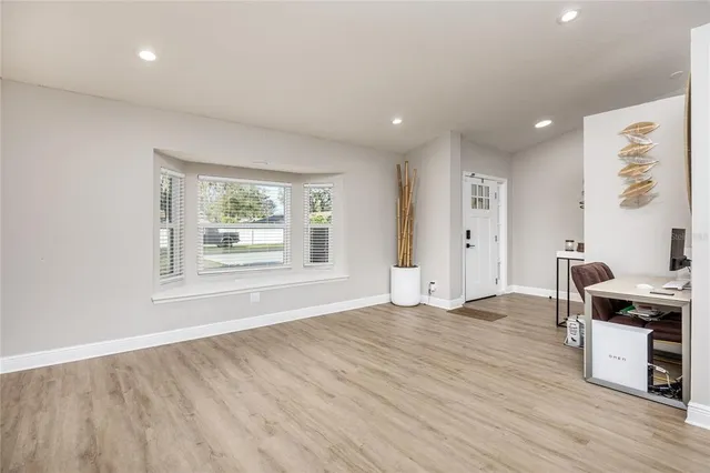 a workspace with wooden floor and windows