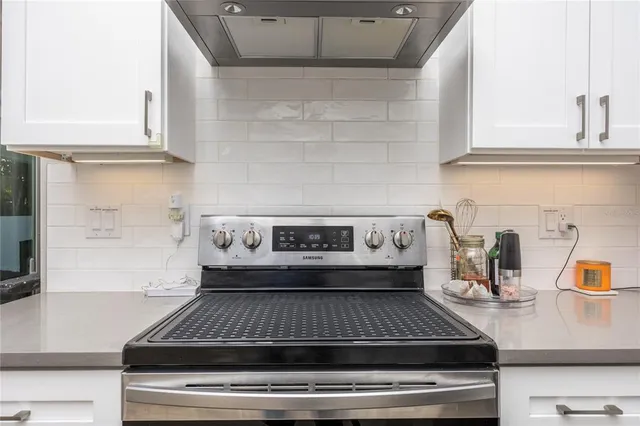 a kitchen with a stove and cabinets