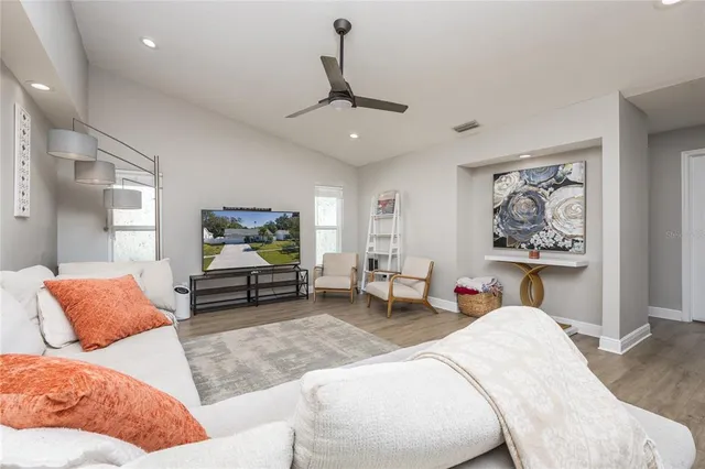 a living room with furniture a couch and a window