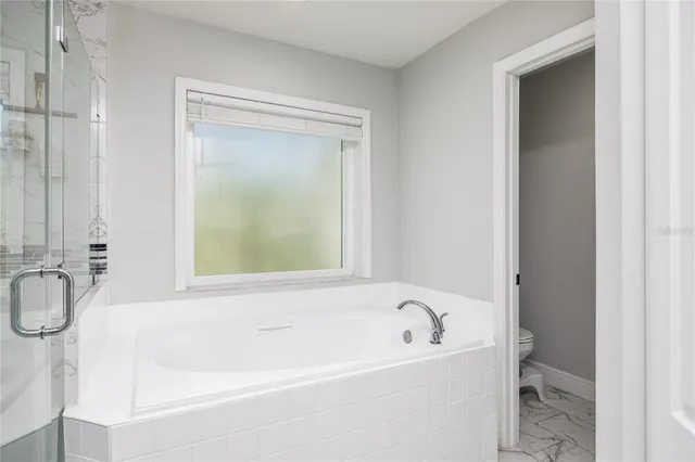 a white bath tub sitting next to a window