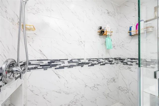 a bathroom with a shower and a sink