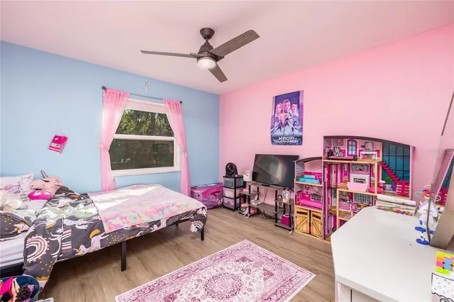 a bedroom with bed and a baby crib