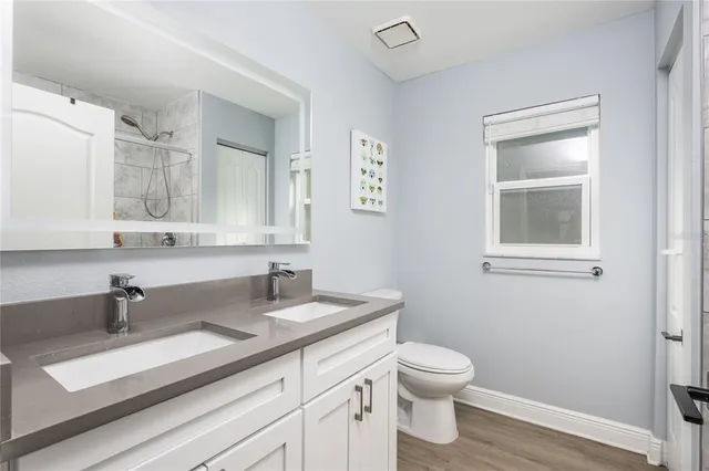 a bathroom with a sink a toilet and a mirror