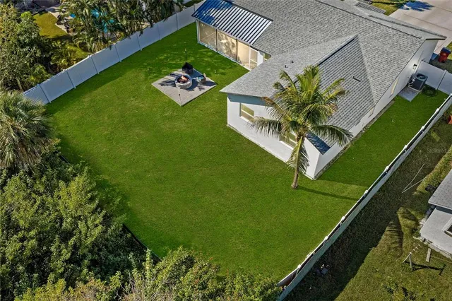 a green field with some trees in the background