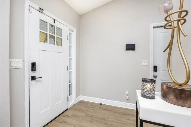 a view of a hallway with wooden floor and entryway