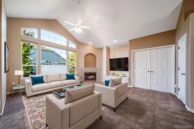 an empty room with windows and fireplace