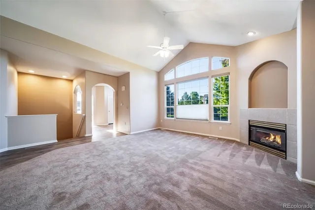 a view of a big room with wooden floor and a ceiling fan