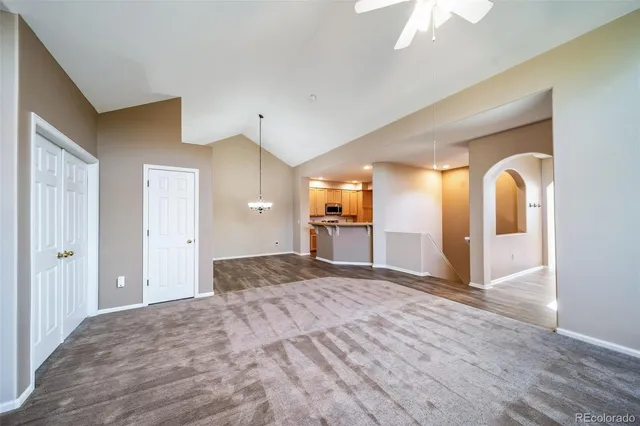 a view of empty room with a fireplace and fan